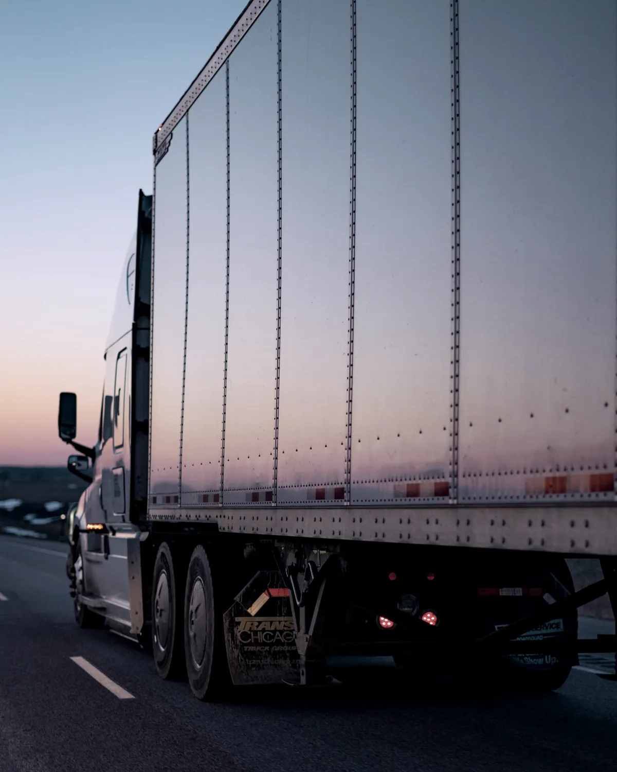 Side of a dry van trailer at sunset